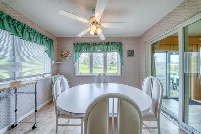a dining room with furniture a chandelier and wooden floor