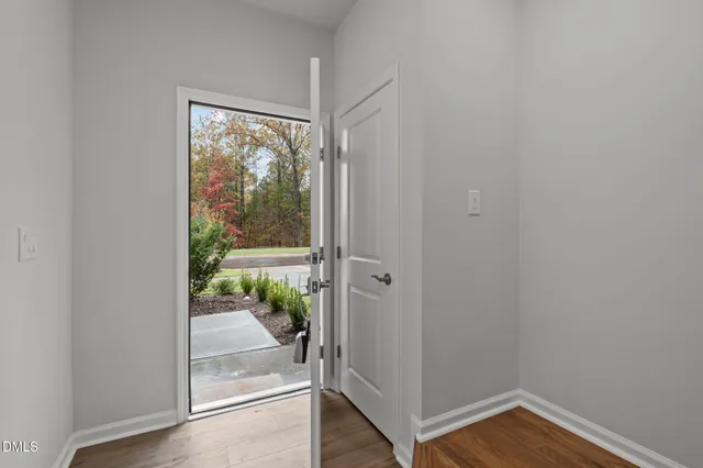 a view of an entryway with wooden floor