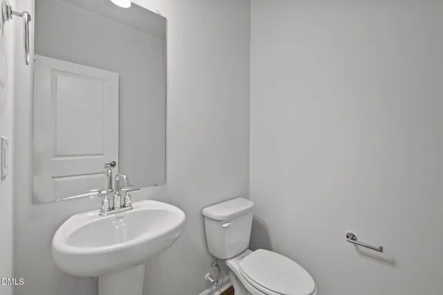 a view of staircase with railing and white walls