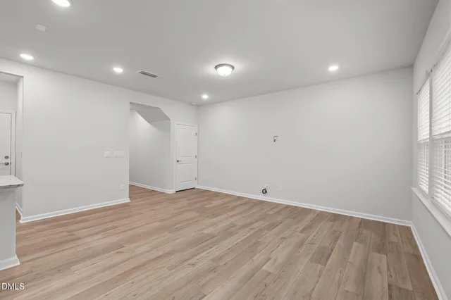 a view of a kitchen with a sink and wooden floor
