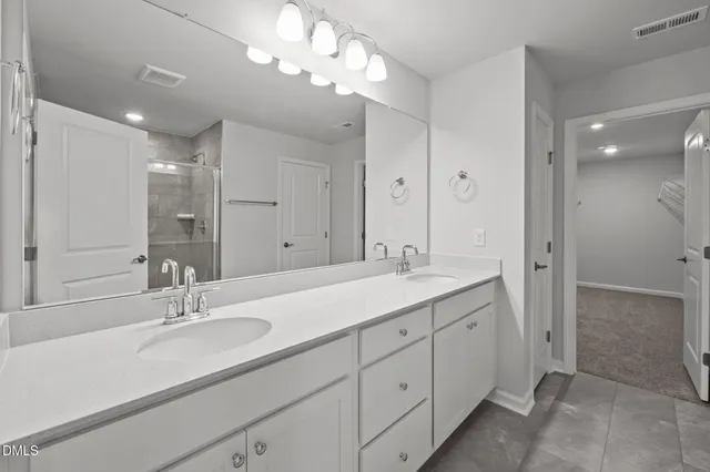 a bathroom with a sink double vanity and a mirror