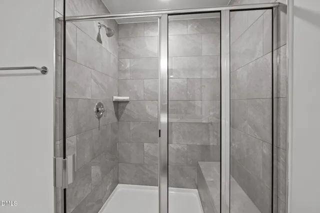 a bathroom with a glass shower door