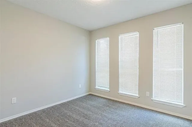 a kitchen with granite countertop white cabinets and a stove a oven with white countertops