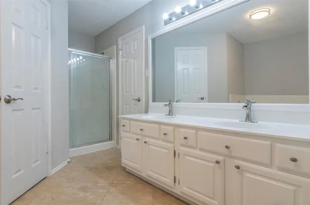 a bathroom with a toilet a sink a vanity and window