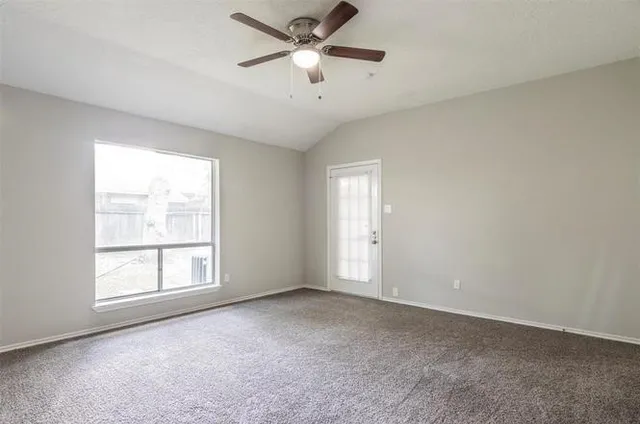 a front view of a house with a garden and yard