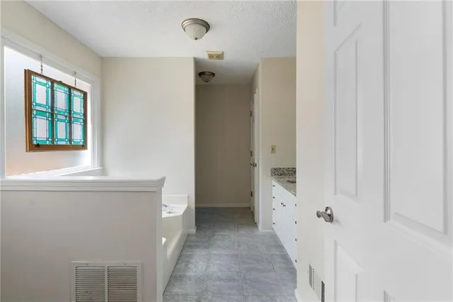 a bathroom with a granite countertop sink a toilet and shower