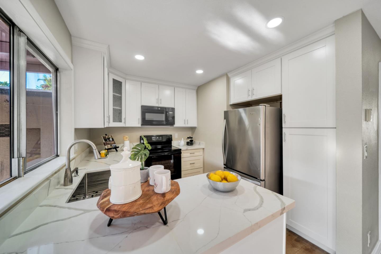 1433 Big Basin Drive Milpitas, CA 95035 - Photo 11 of 23 a view of a kitchen with dining area and stainless steel appliances