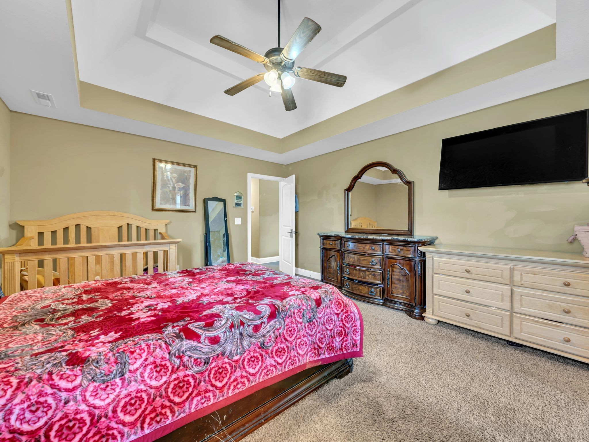 1084 Harrison Way Clarksville, TN 37042 - Photo 16 of 31 a bedroom with a bed a dresser and a flat screen tv