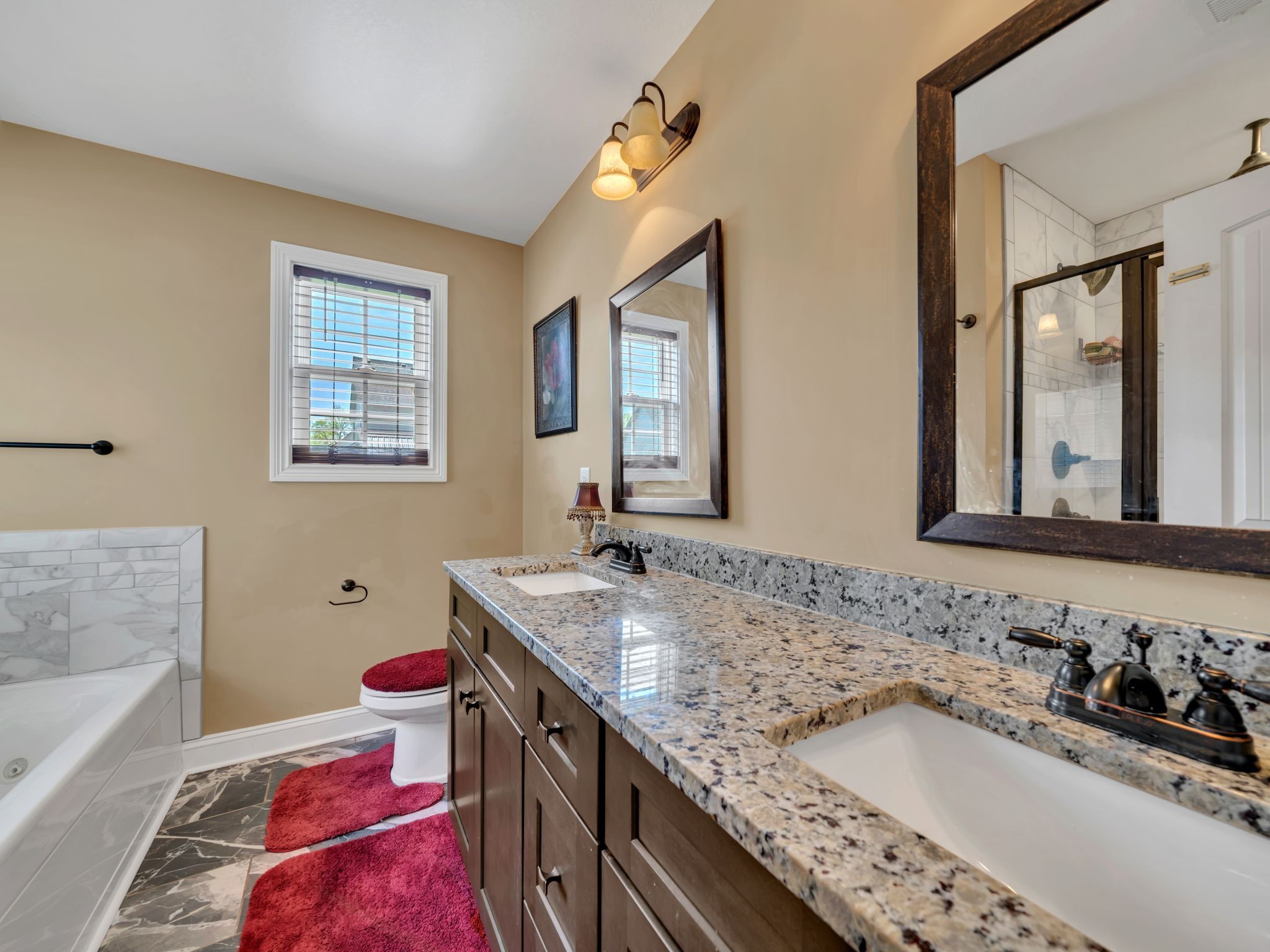 1084 Harrison Way Clarksville, TN 37042 - Photo 17 of 31 a bathroom with a granite countertop double vanity sink and a bathtub