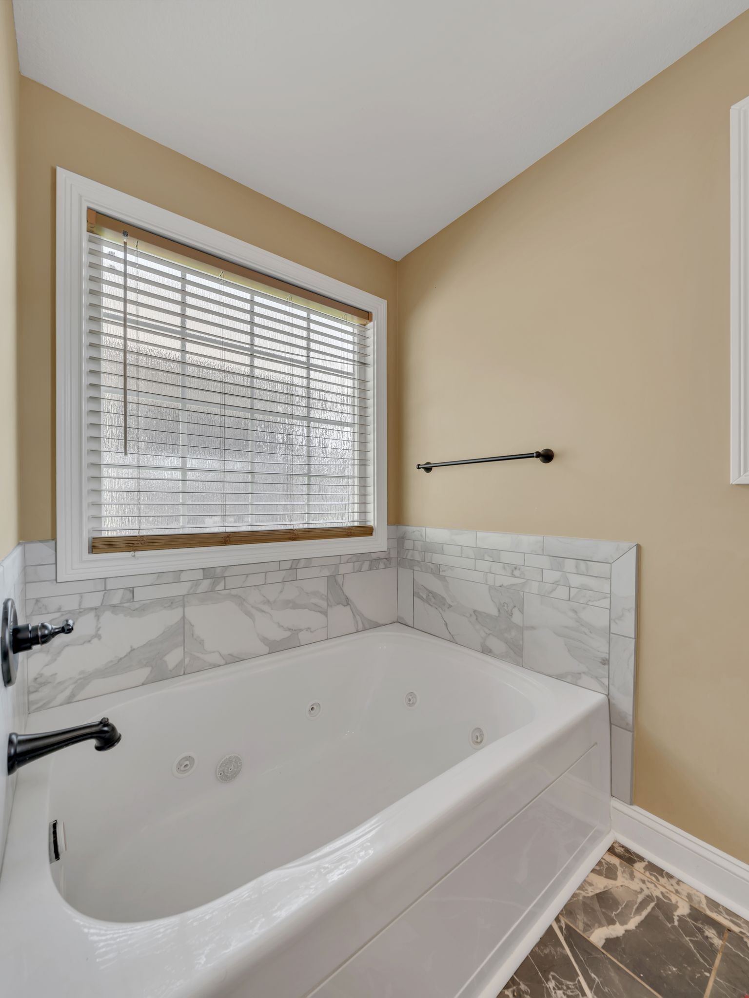 1084 Harrison Way Clarksville, TN 37042 - Photo 18 of 31 a white bath tub sitting in a bathroom next to a window