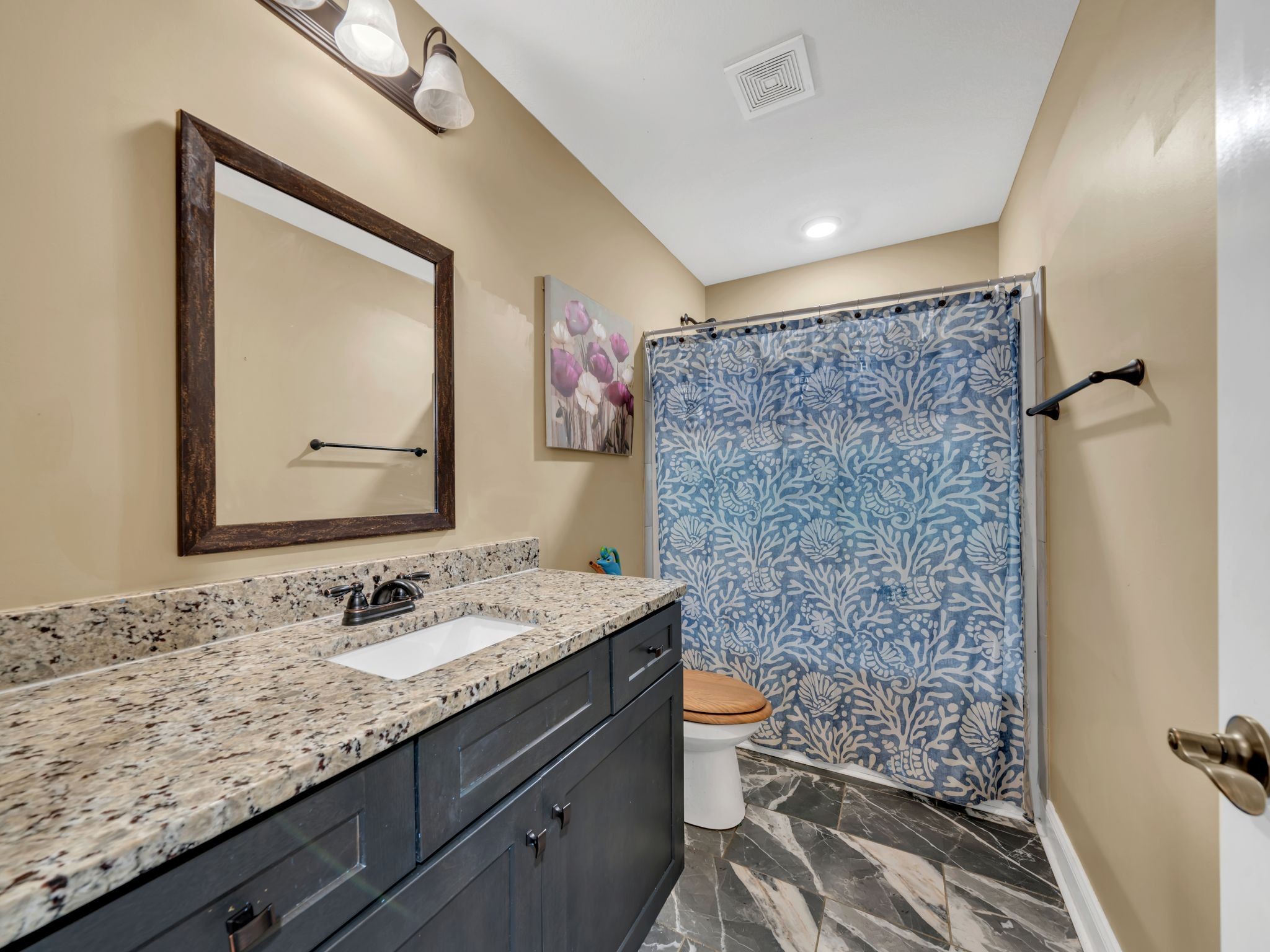 1084 Harrison Way Clarksville, TN 37042 - Photo 22 of 31 a bathroom with a granite countertop sink a toilet and a mirror