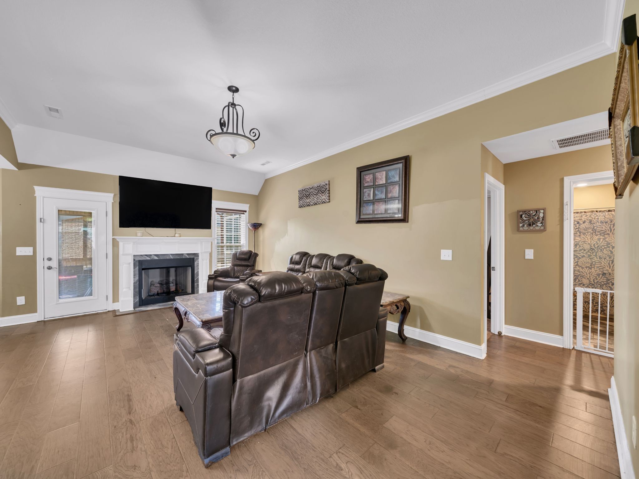 1084 Harrison Way Clarksville, TN 37042 - Photo 7 of 31 a living room with furniture a fireplace and a flat screen tv