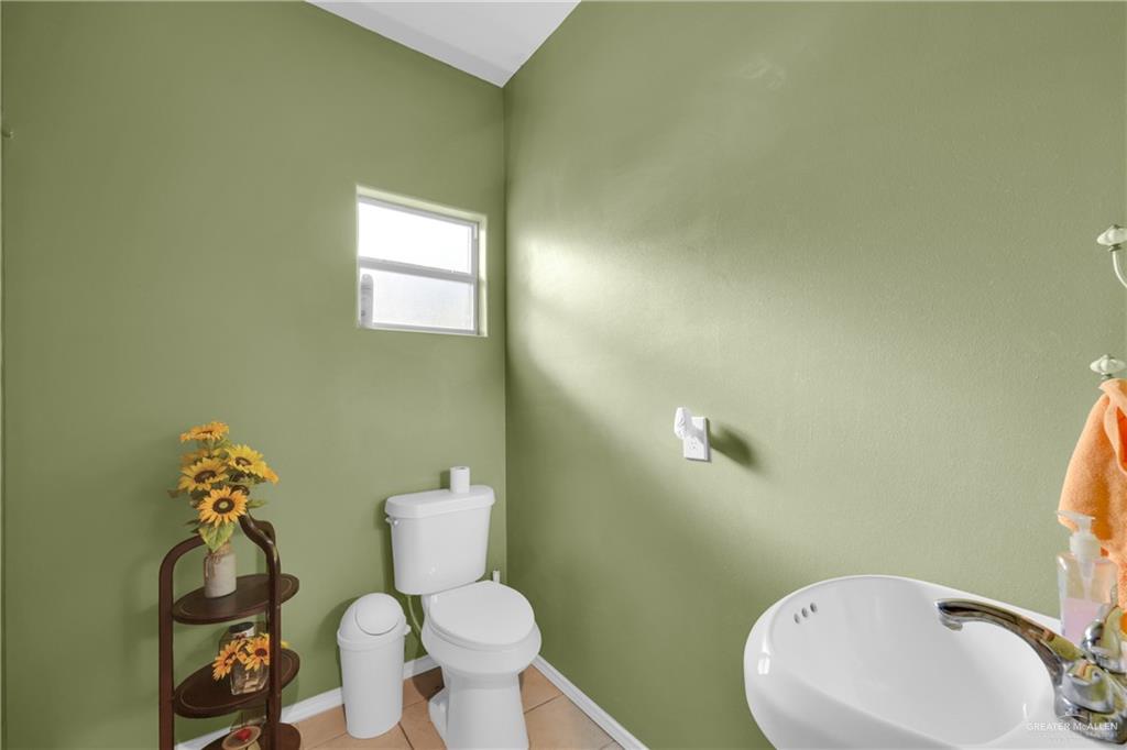 715 North Gonzalez Road Weslaco, TX 78596 - Photo 11 of 31 a bathroom with a toilet sink and mirror