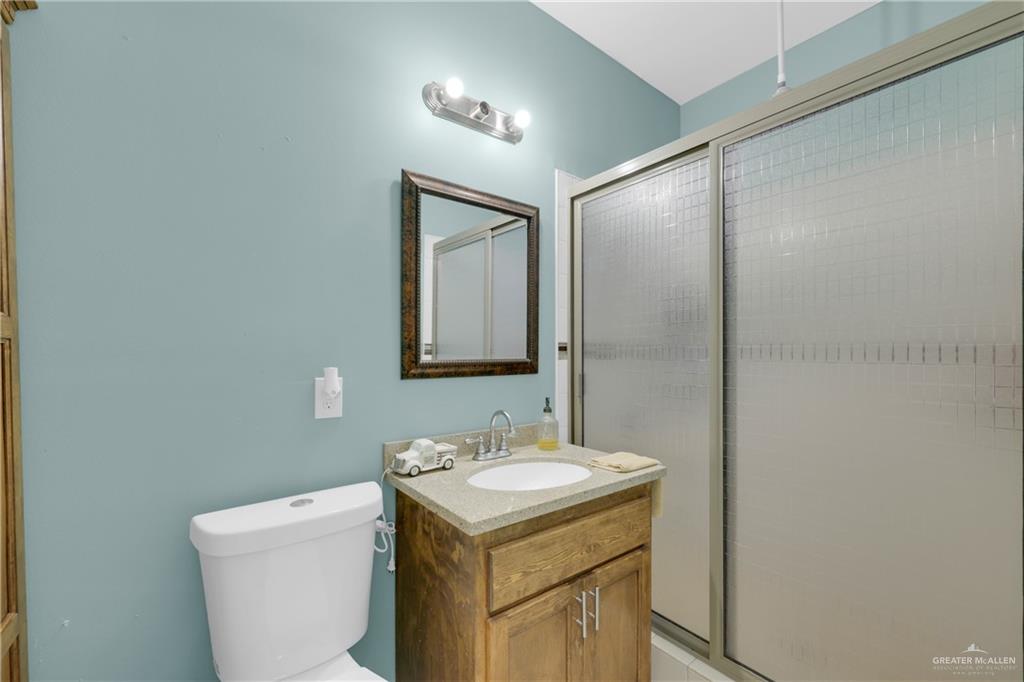 715 North Gonzalez Road Weslaco, TX 78596 - Photo 13 of 31 a bathroom with a sink toilet and mirror