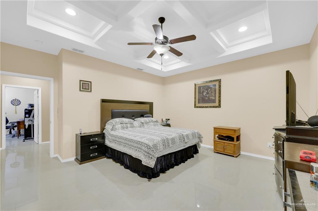 715 North Gonzalez Road Weslaco, TX 78596 - Photo 16 of 31 a bedroom with a bed and a flat screen tv