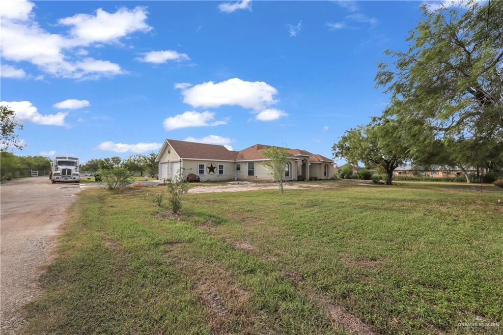 715 North Gonzalez Road Weslaco, TX 78596 - Photo 21 of 31 a view of a big house with a yard