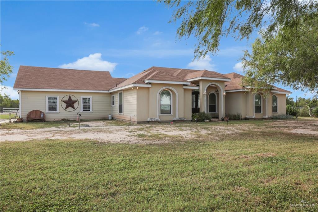 715 North Gonzalez Road Weslaco, TX 78596 - Photo 22 of 31 a front view of a house with a garden