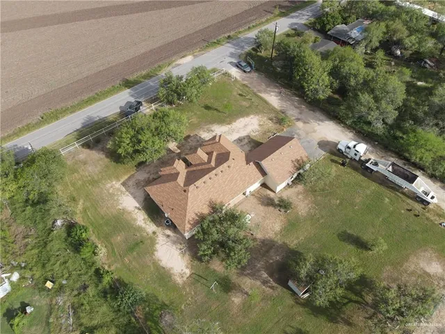 an aerial view of a house with a yard
