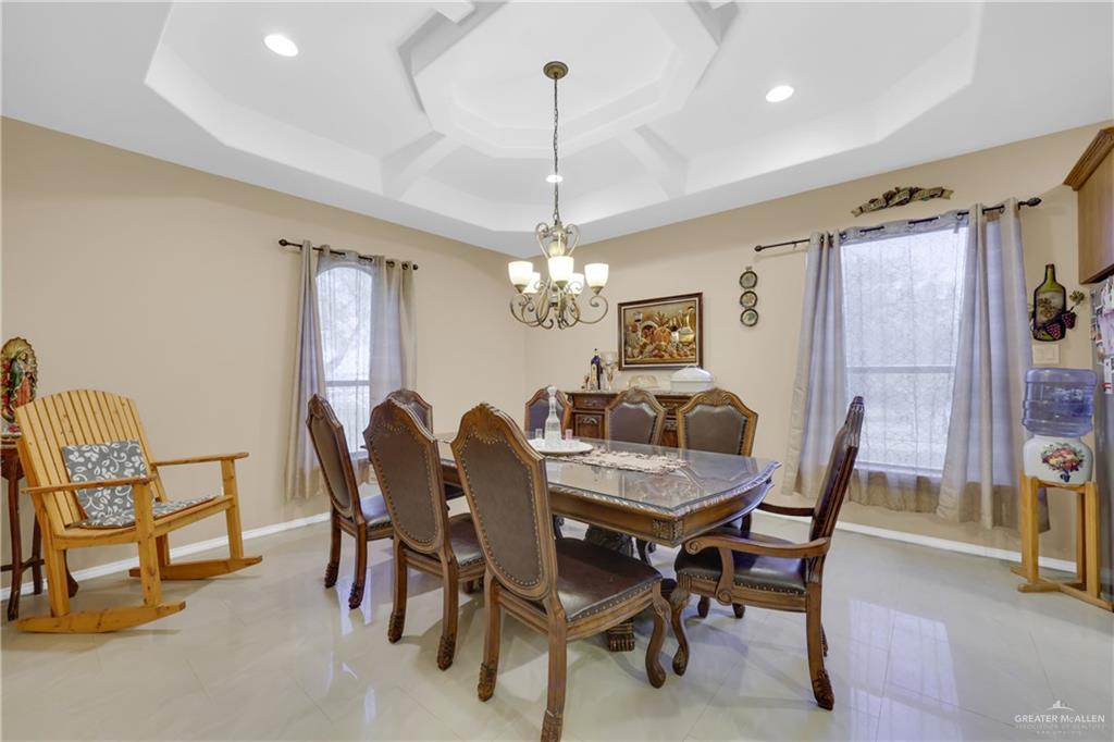 715 North Gonzalez Road Weslaco, TX 78596 - Photo 3 of 31 a dining room with furniture a chandelier and window