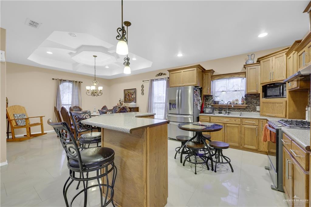 715 North Gonzalez Road Weslaco, TX 78596 - Photo 6 of 31 a kitchen with a table and chairs in it
