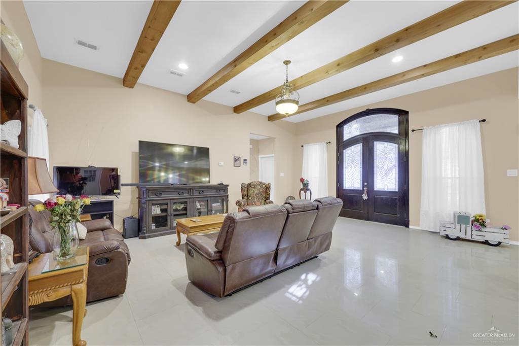 715 North Gonzalez Road Weslaco, TX 78596 - Photo 9 of 31 a living room with furniture and a flat screen tv