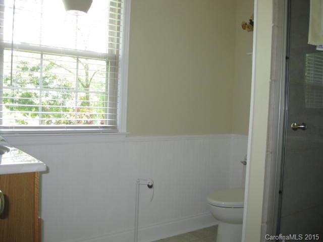 635 Miles Road Dallas, NC 28034 - Photo 12 of 17 a bathroom with a toilet a sink and a window