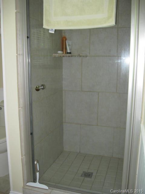 635 Miles Road Dallas, NC 28034 - Photo 14 of 17 a bathroom with a glass shower door