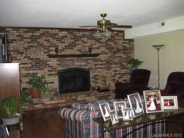 635 Miles Road Dallas, NC 28034 - Photo 3 of 17 a living room with furniture a flat screen tv and a fireplace