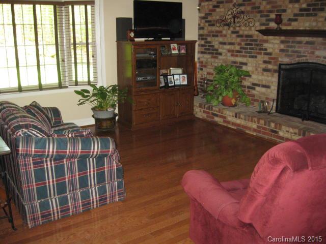 635 Miles Road Dallas, NC 28034 - Photo 4 of 17 a living room with furniture a flat screen tv and a fireplace