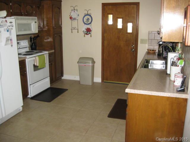 635 Miles Road Dallas, NC 28034 - Photo 5 of 17 a view of a kitchen with fridge and wooden floor