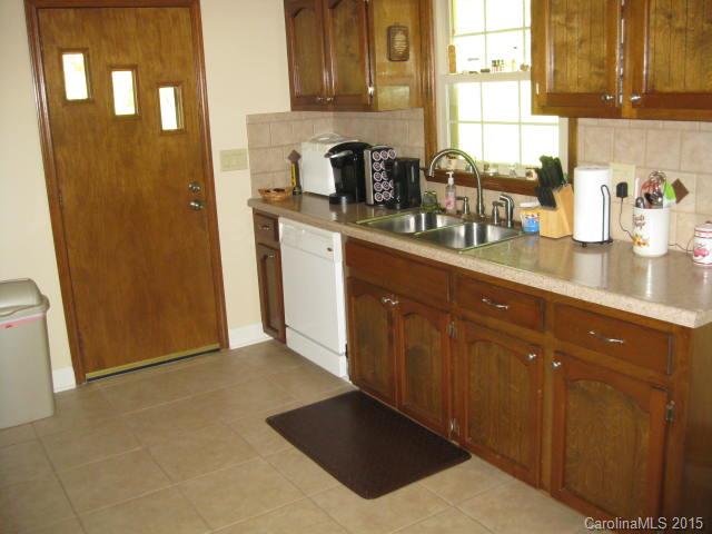 635 Miles Road Dallas, NC 28034 - Photo 6 of 17 a kitchen with stainless steel appliances granite countertop a refrigerator a sink and wooden cabinets