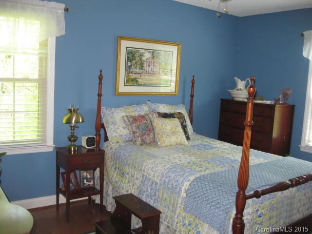 635 Miles Road Dallas, NC 28034 - Photo 9 of 17 a bedroom with a bed and wooden floor