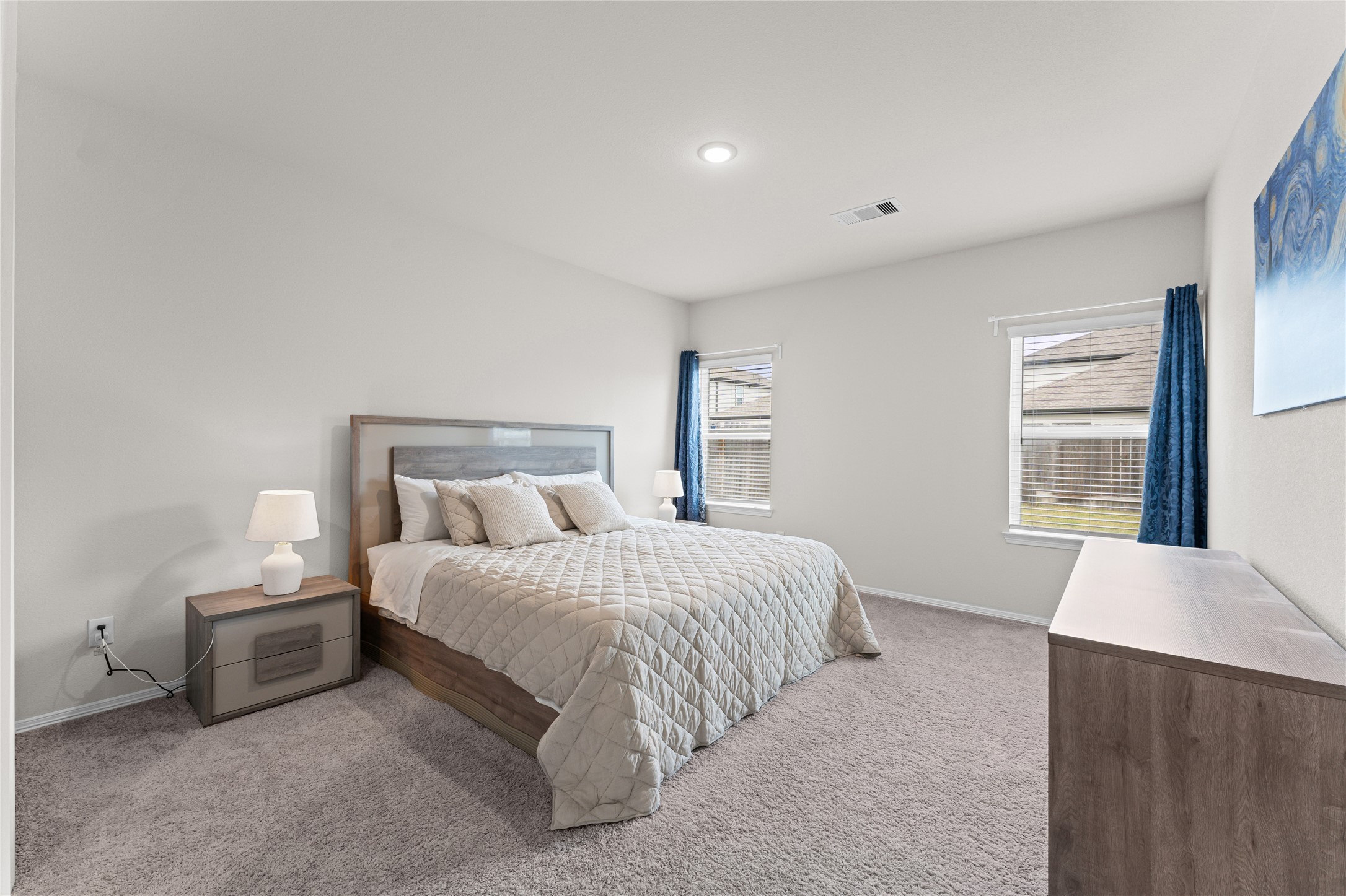 23326 Spring Genesis Lane Katy, TX 77493 - Photo 13 of 32 The first-floor primary suite serves as a serene sanctuary, offering a peaceful view of the backyard to start your mornings right.