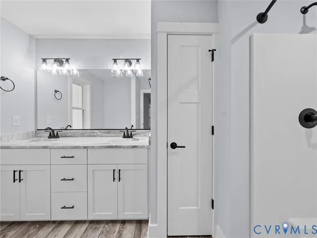 a bathroom with double sink and a mirror
