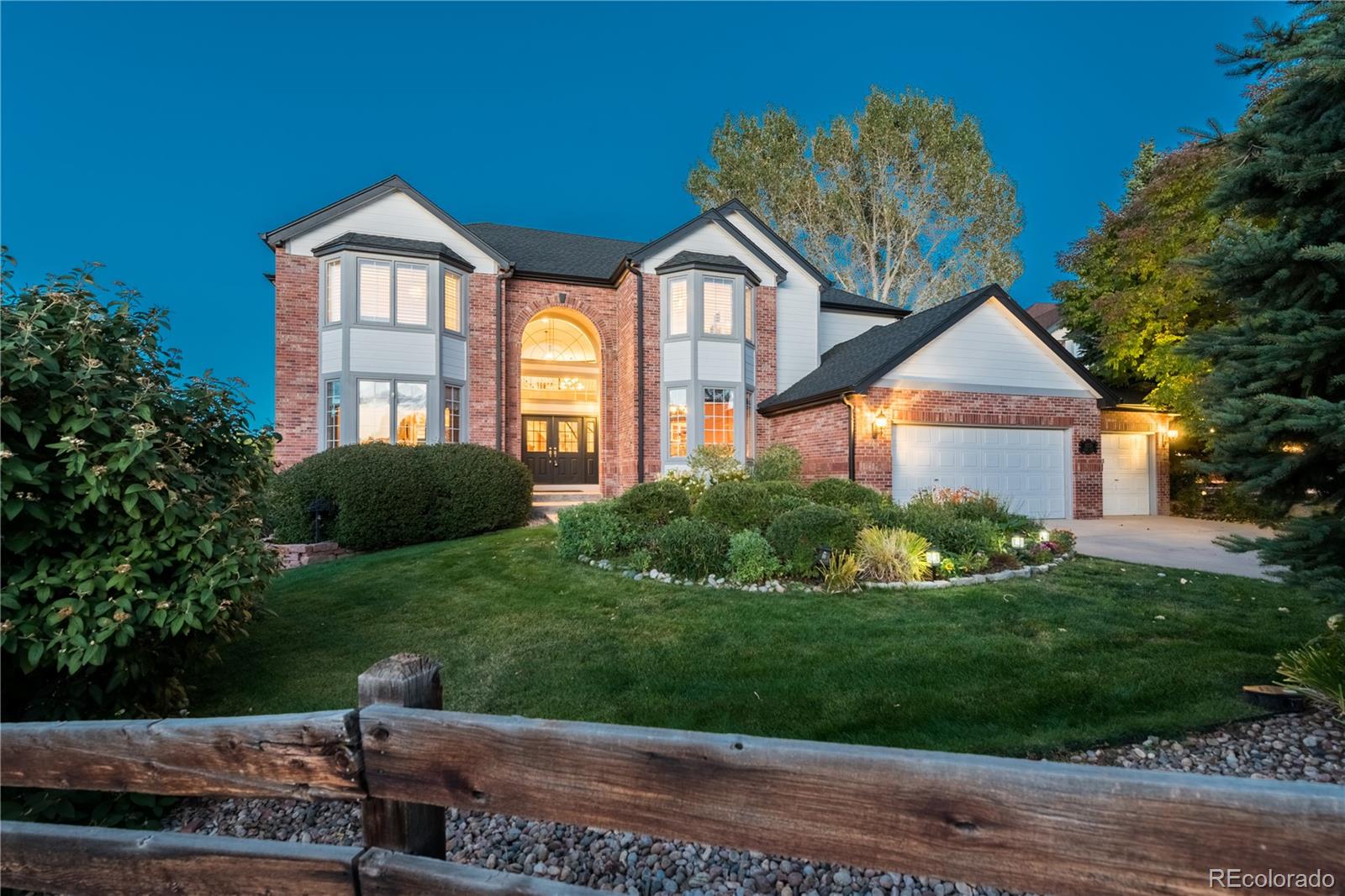 10734 Cougar Ridge Lone Tree, CO 80124 - Photo 1 of 35 a front view of a house with a yard