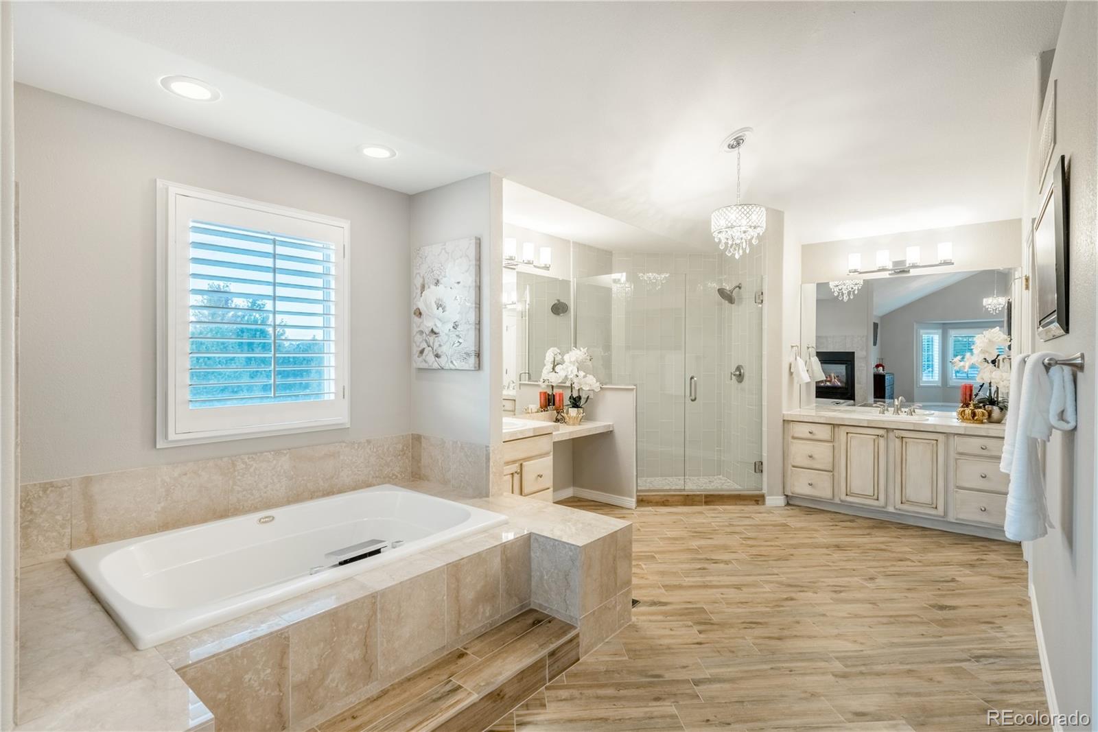 10734 Cougar Ridge Lone Tree, CO 80124 - Photo 12 of 35 a spacious bathroom with a tub a sink and mirror