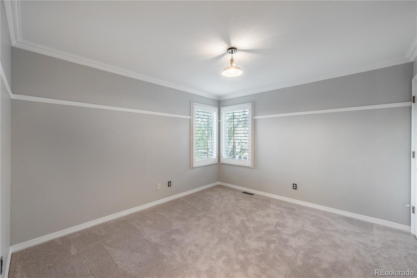 10734 Cougar Ridge Lone Tree, CO 80124 - Photo 17 of 35 an empty room with windows and chandelier fan