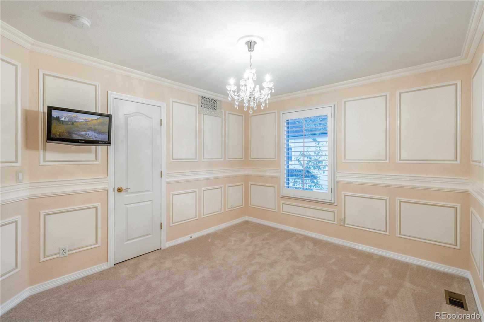 10734 Cougar Ridge Lone Tree, CO 80124 - Photo 18 of 35 a view of a kitchen with white cabinets and chandelier