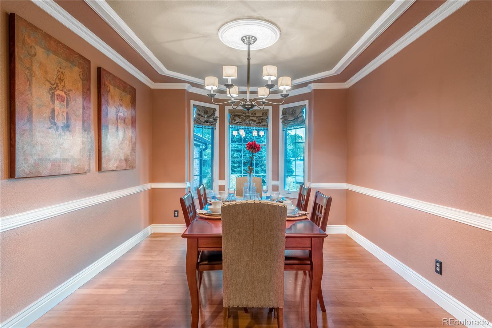 10734 Cougar Ridge Lone Tree, CO 80124 - Photo 20 of 35 a view of a dining room with furniture a chandelier and wooden floor