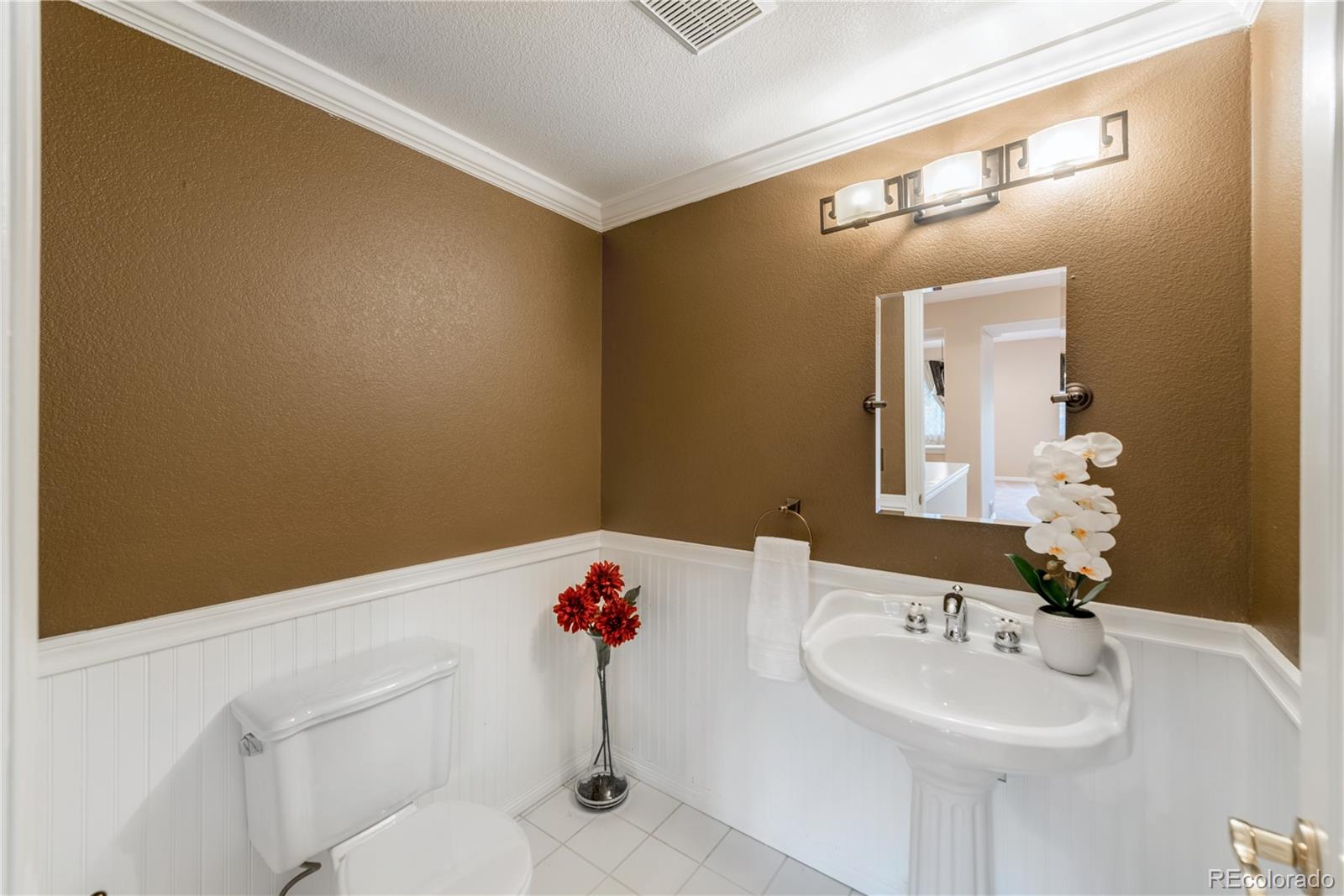 10734 Cougar Ridge Lone Tree, CO 80124 - Photo 27 of 35 a bathroom with a sink and a mirror