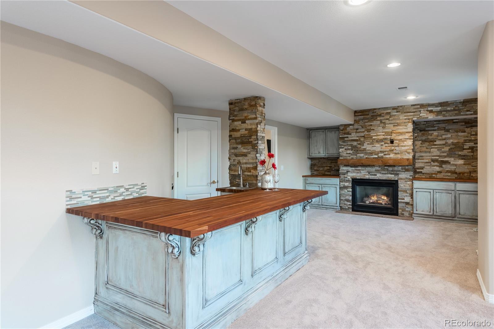 10734 Cougar Ridge Lone Tree, CO 80124 - Photo 28 of 35 a view of a kitchen cabinets and fireplace