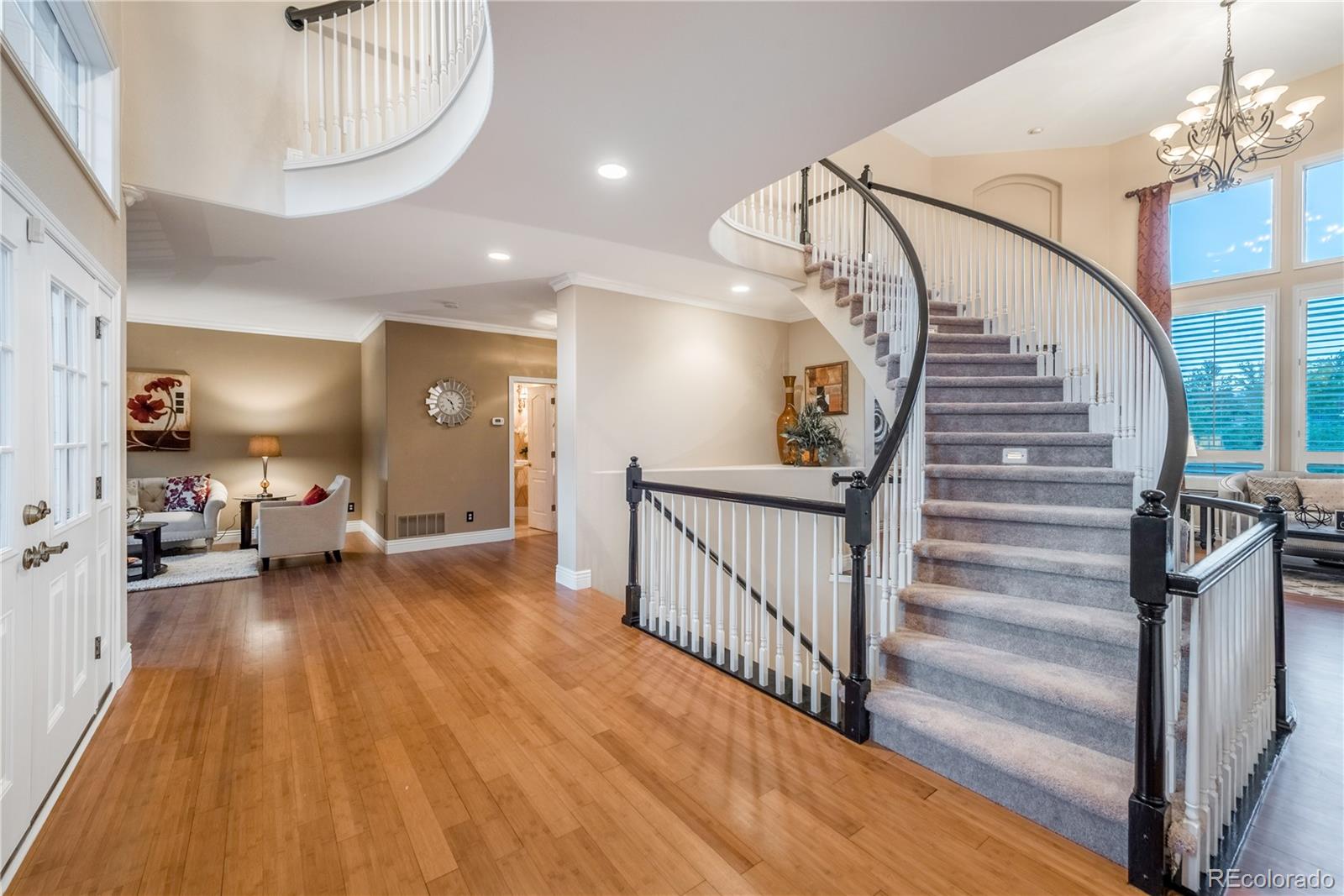 10734 Cougar Ridge Lone Tree, CO 80124 - Photo 3 of 35 a view of staircase with a table and a chandelier