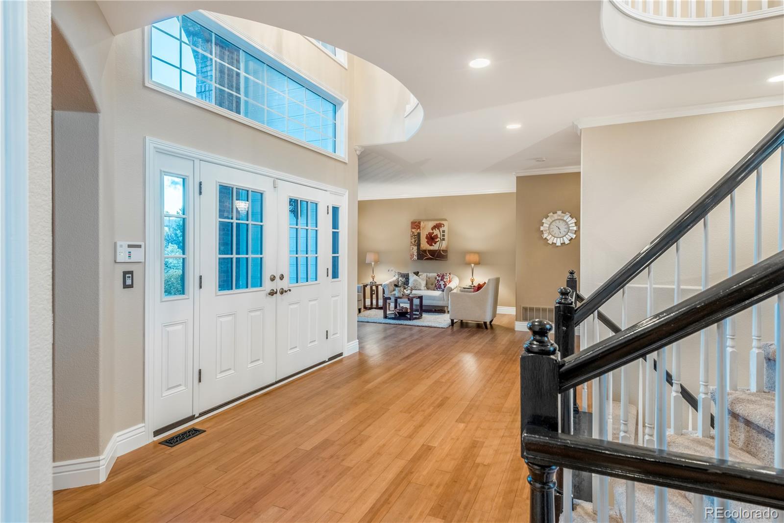 10734 Cougar Ridge Lone Tree, CO 80124 - Photo 4 of 35 a view of an entryway with wooden floor and windows
