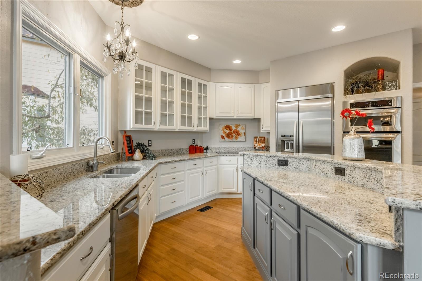 10734 Cougar Ridge Lone Tree, CO 80124 - Photo 7 of 35 a kitchen with stainless steel appliances granite countertop a sink stove and refrigerator
