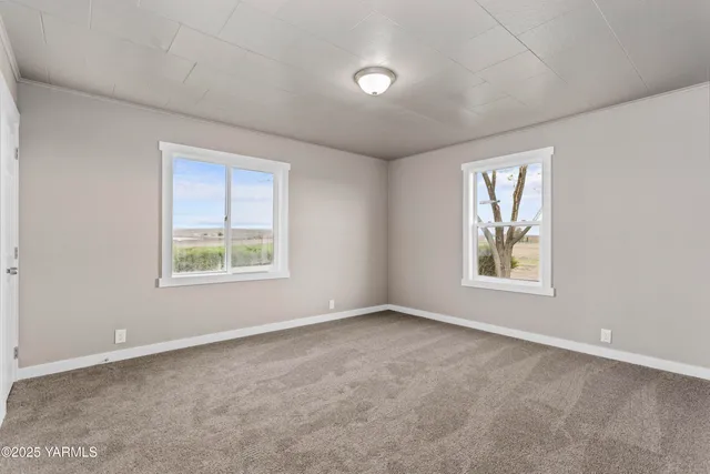 an empty room with a empty space and windows