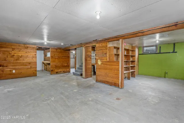a view of room with cabinets and book shelf