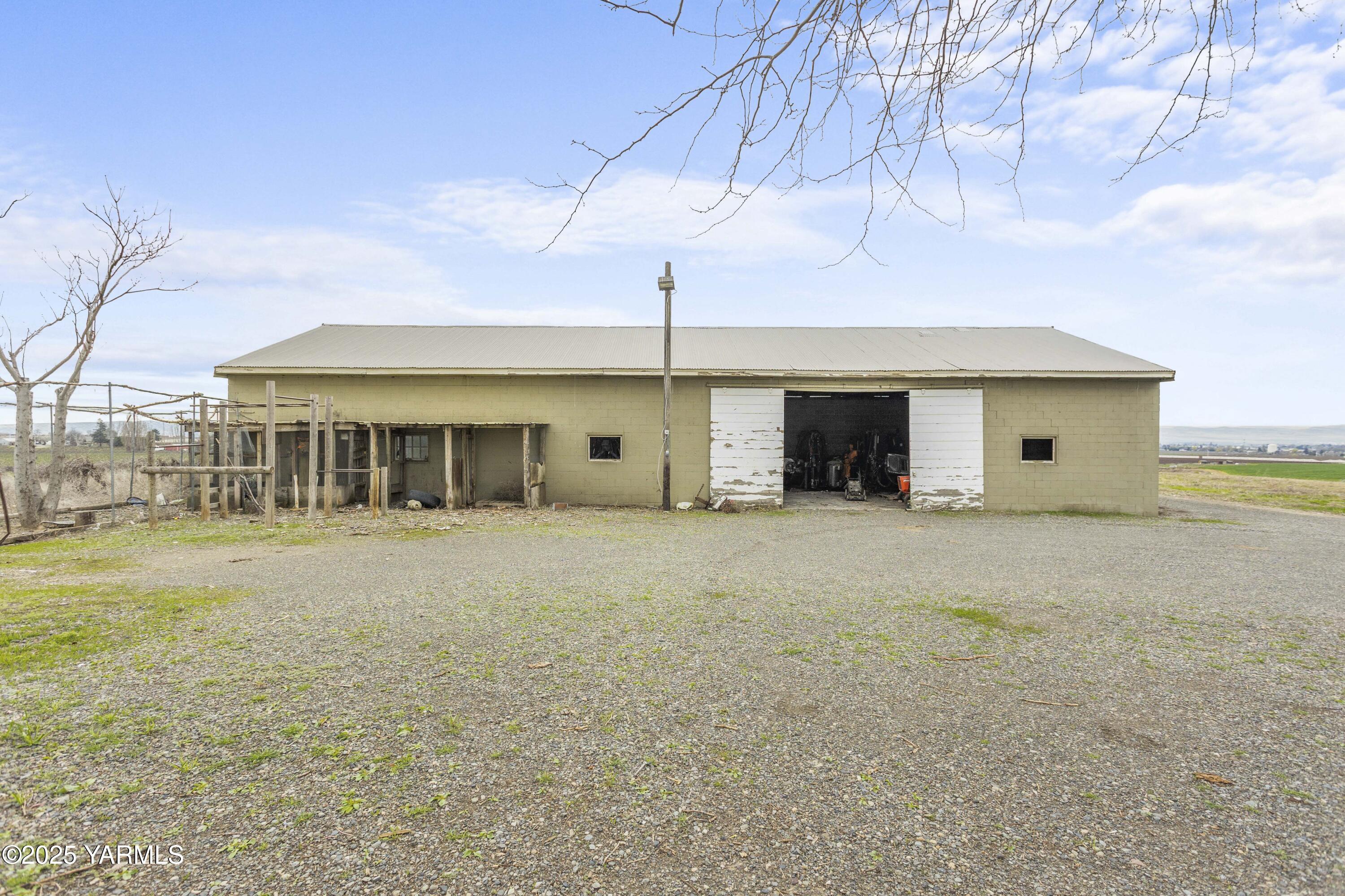 173801 Evans Road Grandview, WA 98930 - Photo 28 of 45 a view of a house with a backyard and a tree