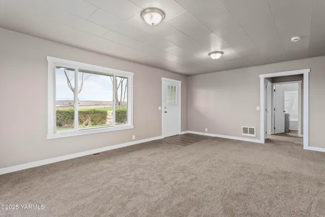 an empty room with windows and closet