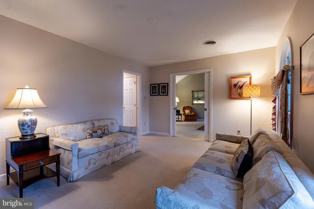a view of a bedroom with furniture and chandelier