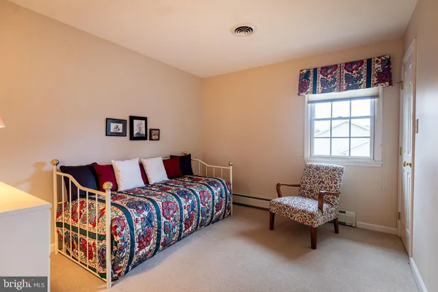 a bedroom with furniture and a window